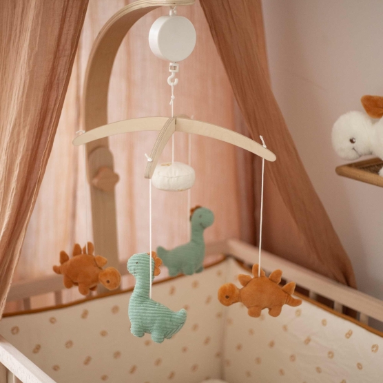 Musical mobile with little Dinos in a cozy room