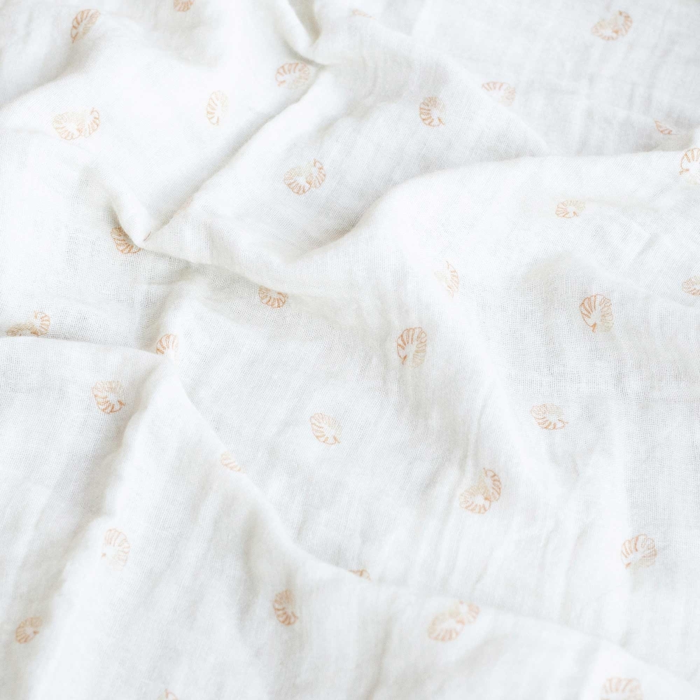 Off-white swaddle with terracotta leaf patterns Off-white swaddle with terracotta leaf patterns