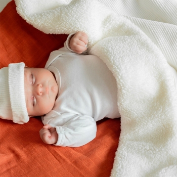Baby sleeping soundly and warm under their sherpa blanket
