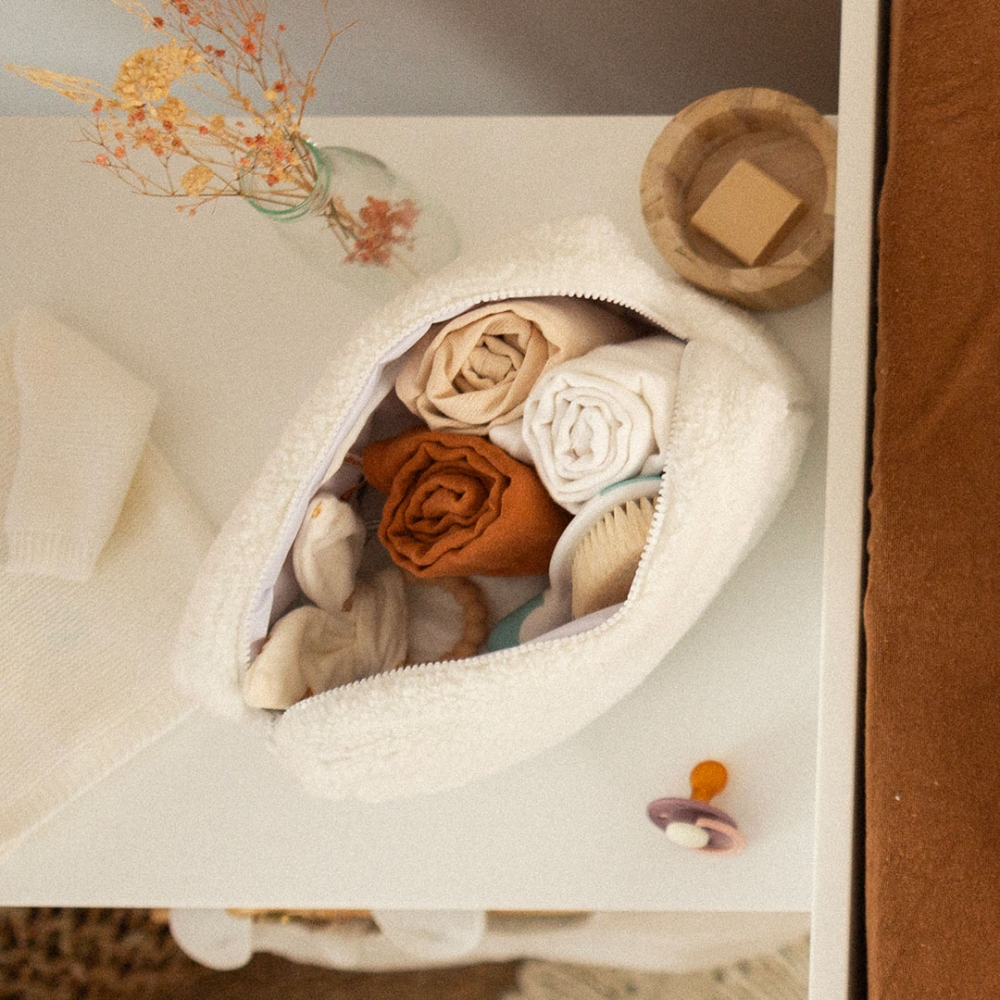 Open baby toiletry bag with baby essentials. Open baby toiletry bag with baby essentials.