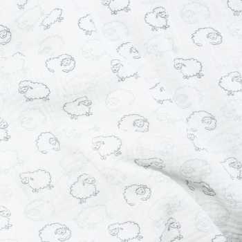 Pormenor do tecido e dos motivos da manta branca para bebé