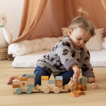 Baby playing with stackable wooden train Baby playing with stackable wooden train