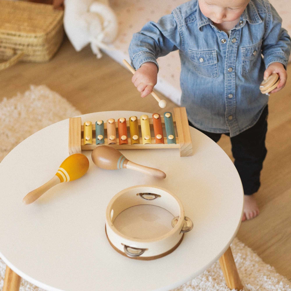 Baby playing with wooden instruments