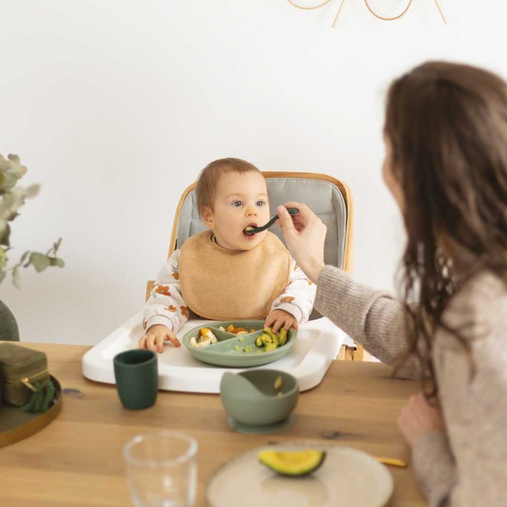 bebé à mesa com colher de silicone