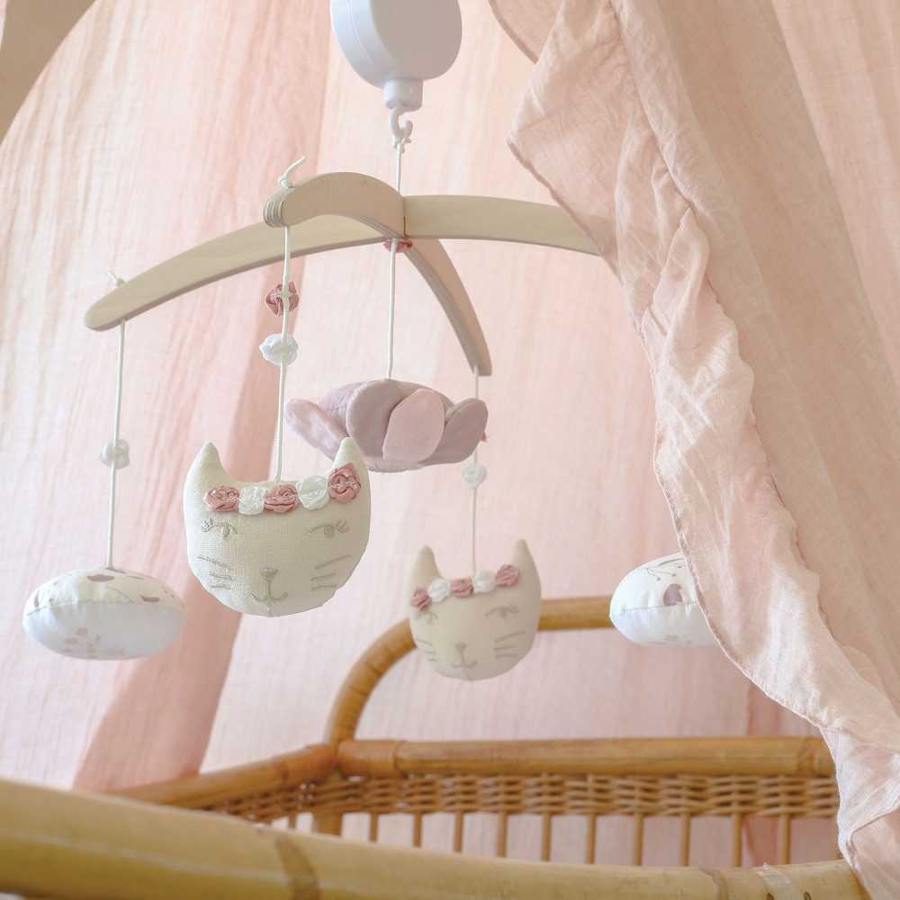 Móbile musical por cima da cama de rotim Móbile musical por cima da cama de rotim