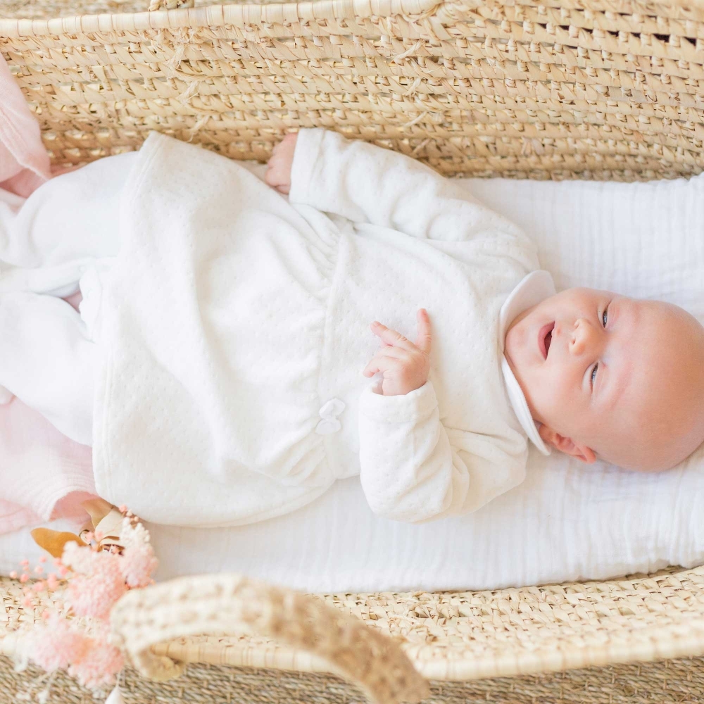 Baby sleeping in white Sophie the Giraffe pajama dress