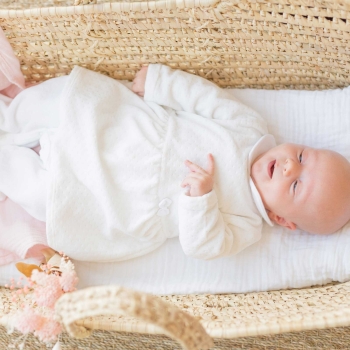 Baby sleeping in white Sophie the Giraffe pajama dress