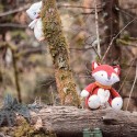 Musical owl plush hidden behind the tree to observe the fox Musical owl plush hidden behind the tree to observe the fox