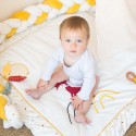 Little girl sitting on her play mat surrounded by the decorative braid Little girl sitting on her play mat surrounded by the decorative braid