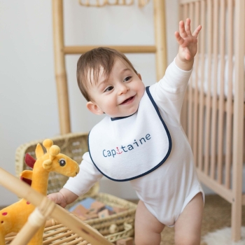 Baby boy having fun with his bib Baby boy having fun with his bib