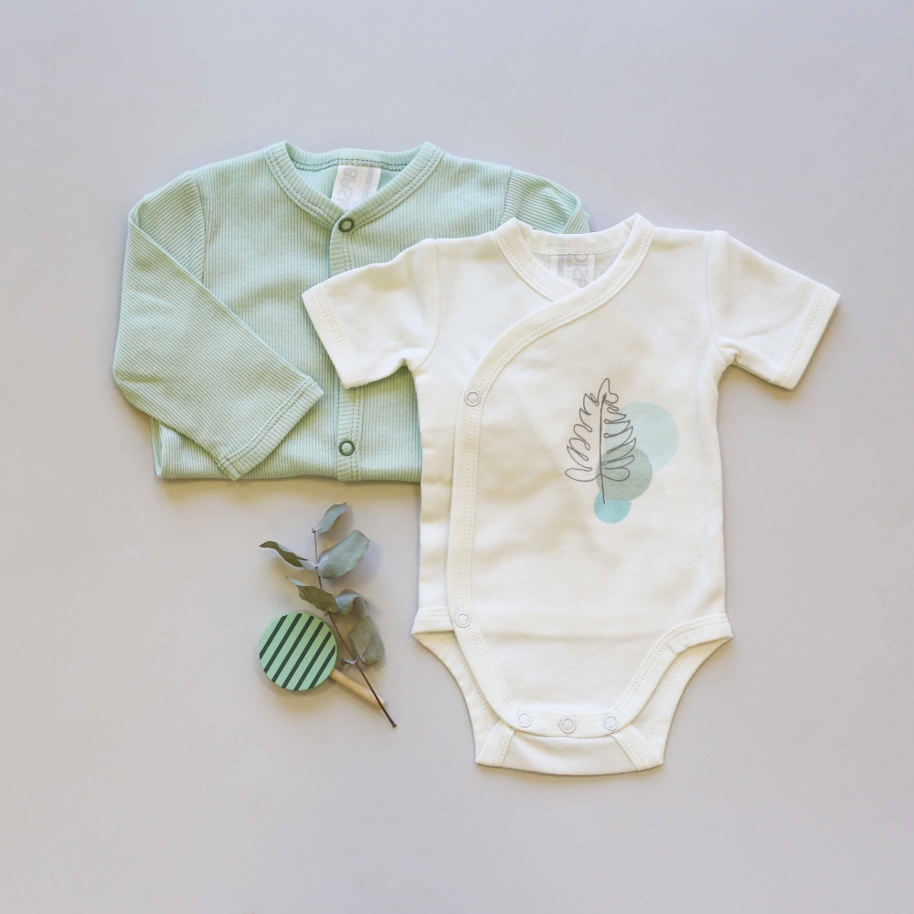 Staging of the ecru bodysuit with a sage corduroy pajama Staging of the ecru bodysuit with a sage corduroy pajama