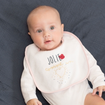 Little girl and her pink and blue bib Little girl and her pink and blue bib