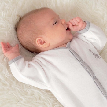 baby in white pajamas