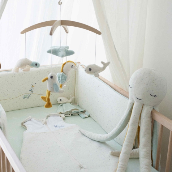beige and light green crib bumper for high position crib