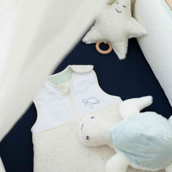 heathered sleeping bag with turtle embroidery on top