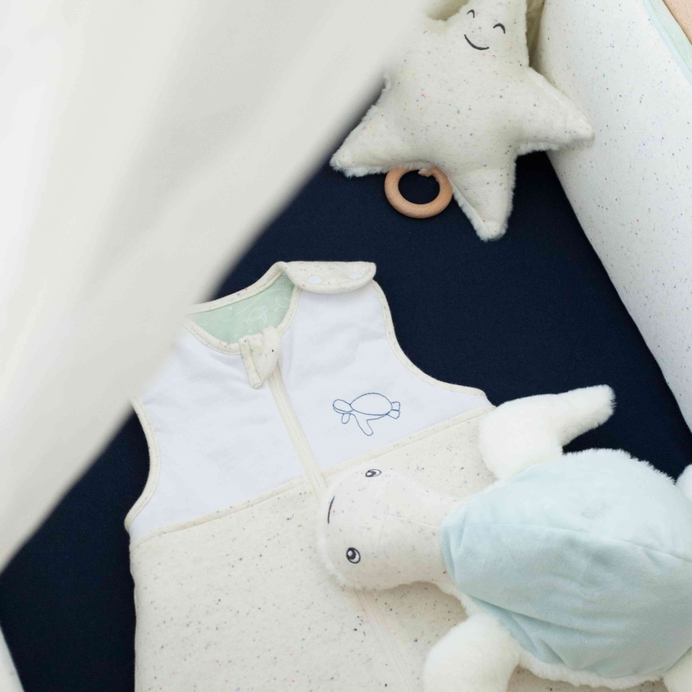 heathered embroidered sleep sack in the baby bed