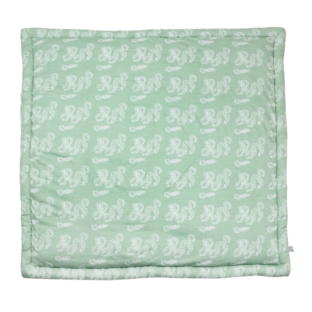 playpen mat with a white leaf pattern on a sage green background