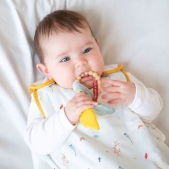 baby with teething rattle in mouth baby with teething rattle in mouth