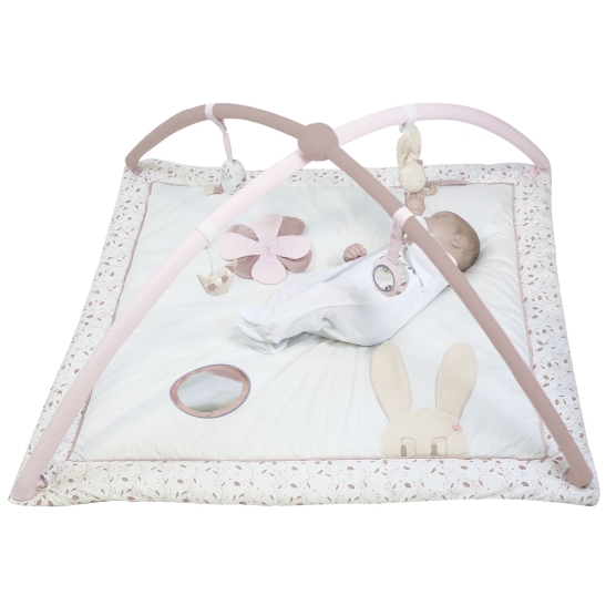 Pink and white play mat with a little baby lying on it