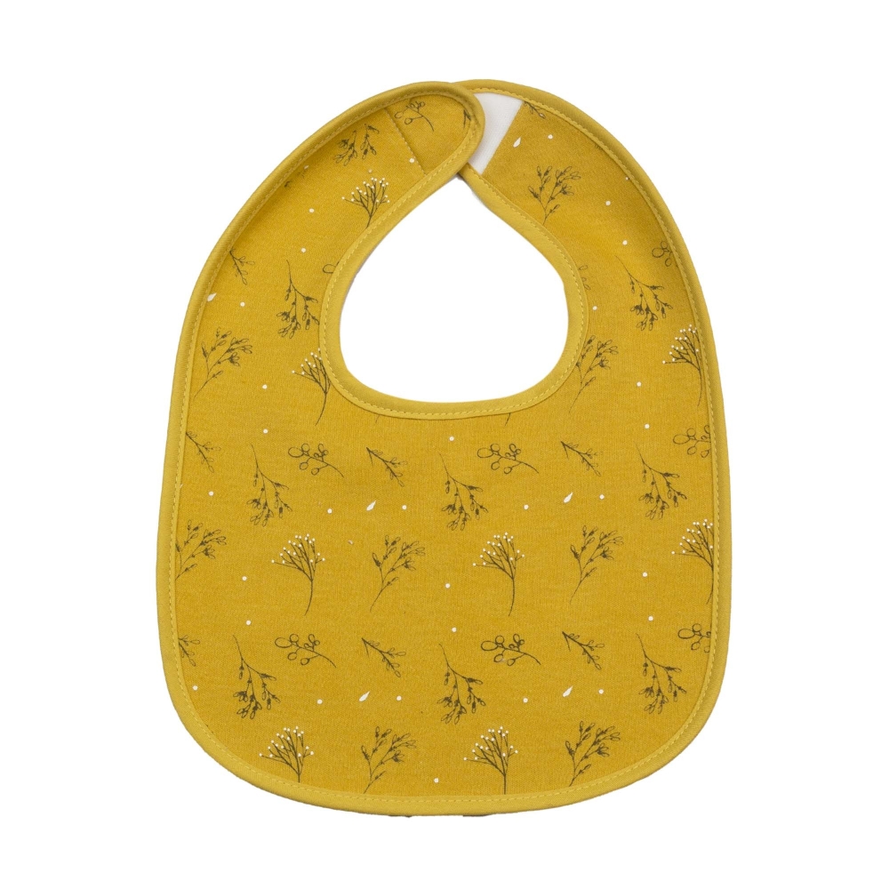 Beautiful mustard-colored bib with an all-over floral pattern Beautiful mustard-colored bib with an all-over floral pattern