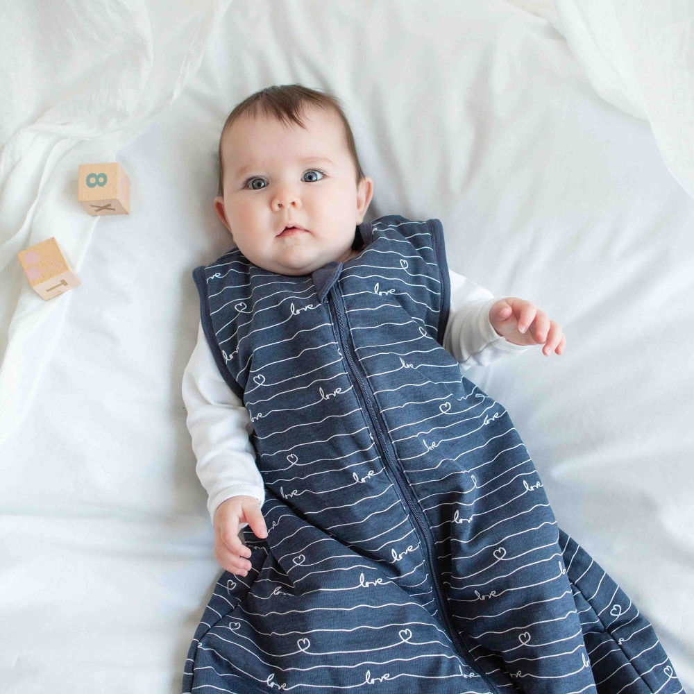 Baby in their summer sleeping bag in navy blue color Baby in their summer sleeping bag in navy blue color